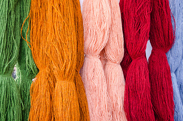 Image showing background of various colors wool threads closeup 