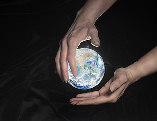 Image showing crystal globe and hands