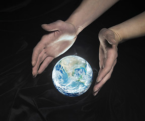 Image showing crystal globe and hands