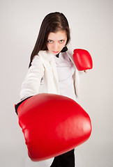 Image showing young businesswoman in boxing gloves