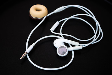 Image showing White ear buds and line store isolated on dark background