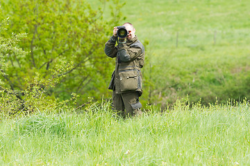 Image showing Wildlife photographer with long telephoto