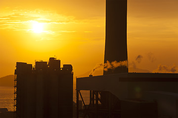 Image showing Air pollution from factories in sunset