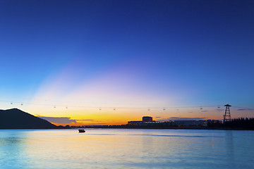 Image showing Sunset in Hong Kong along seashore and mountains