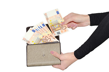 Image showing Beautiful woman's hands holding purse with fan of money isolate