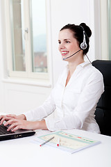 Image showing smiling young female callcenter agent with headset