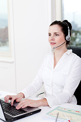 Image showing smiling young female callcenter agent with headset