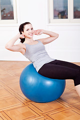 Image showing attractive young woman doing sit ups 