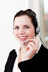 Image showing smiling young female callcenter agent with headset