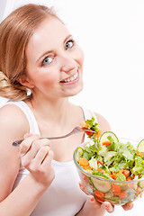 Image showing smiling woman eating fresh salad