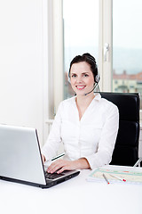 Image showing smiling young female callcenter agent with headset