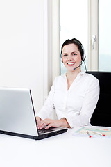 Image showing smiling young female callcenter agent with headset