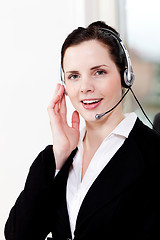 Image showing smiling young female callcenter agent with headset