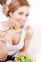 Image showing smiling woman eating fresh salad