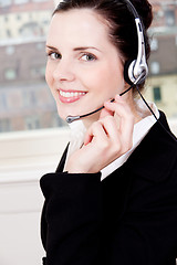 Image showing smiling young female callcenter agent with headset