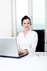 Image showing smiling young female callcenter agent with headset