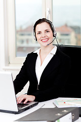 Image showing smiling young female callcenter agent with headset