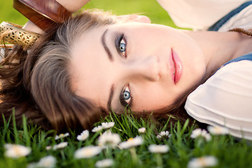 Image showing beautiful woman lying in grass in summer 