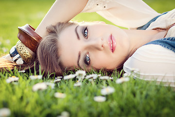 Image showing beautiful woman lying in grass in summer 
