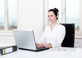 Image showing smiling young female callcenter agent with headset