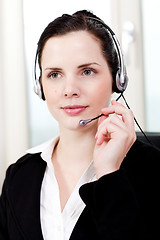 Image showing smiling young female callcenter agent with headset