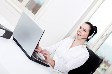 Image showing smiling young female callcenter agent with headset