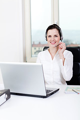 Image showing smiling young female callcenter agent with headset