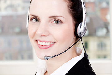 Image showing smiling young female callcenter agent with headset