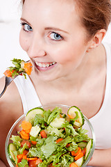 Image showing smiling woman eating fresh salad