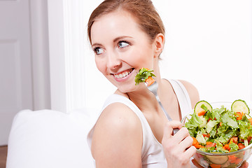 Image showing smiling woman eating fresh salad