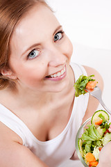 Image showing smiling woman eating fresh salad