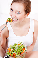 Image showing smiling woman eating fresh salad