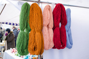 Image showing woollen thread bunches sell outdoor market fair 