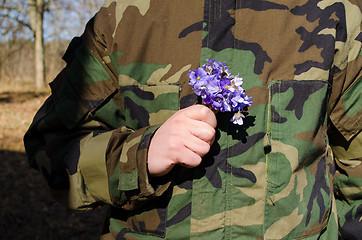 Image showing soldier camouflage hand violet flowers girlfriend 