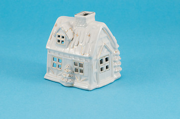 Image showing white ceramic toy house decoration blue background 