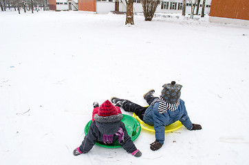 Image showing children sitting on the slides weary after ride  