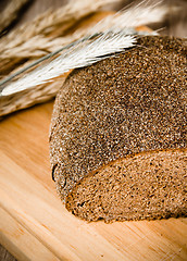 Image showing Black homemade bread and rye cones, close-up 