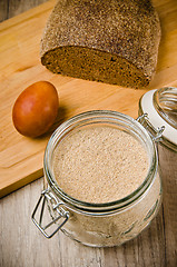 Image showing Black homemade bread, rye flour and egg , close-up 