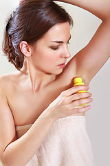 Image showing woman applying deodorant