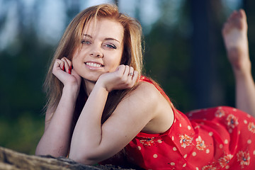 Image showing Girl lying on a log