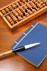 Image showing chinese book , abacus and writing brush