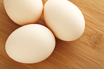 Image showing Fresh egg on wooden table