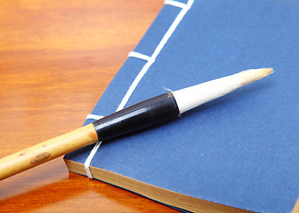 Image showing Chinese book and writing brush