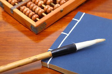 Image showing chinese book , abacus and writing brush
