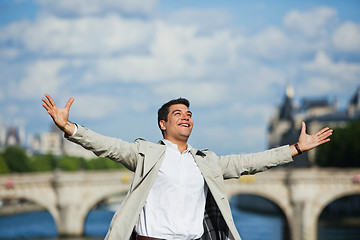 Image showing Man smiling with his arm outstretched