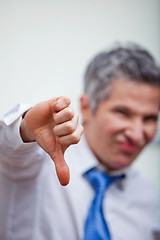 Image showing Businessman gesturing thumbs down sign