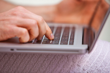 Image showing Mid section view of a man using a laptop