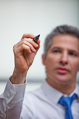 Image showing Businessman writing with a felt tip pen