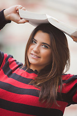 Image showing Woman overweight with book on her head