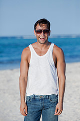 Image showing Man wearing sunglasses and laughing on the beach